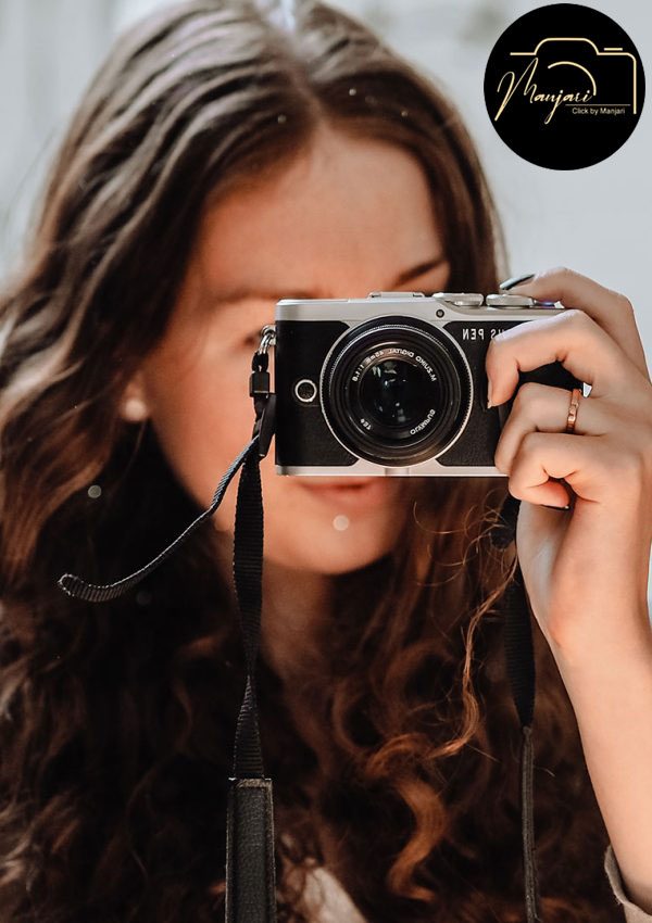 A photographer looking through her camera