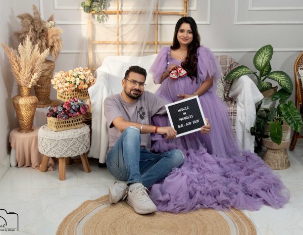A couple celebrating their maternity journey in the Click By Manjari studio