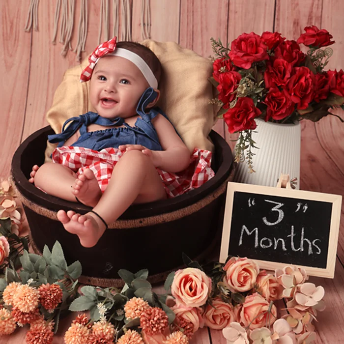 Smiling baby in a floral portrait setting