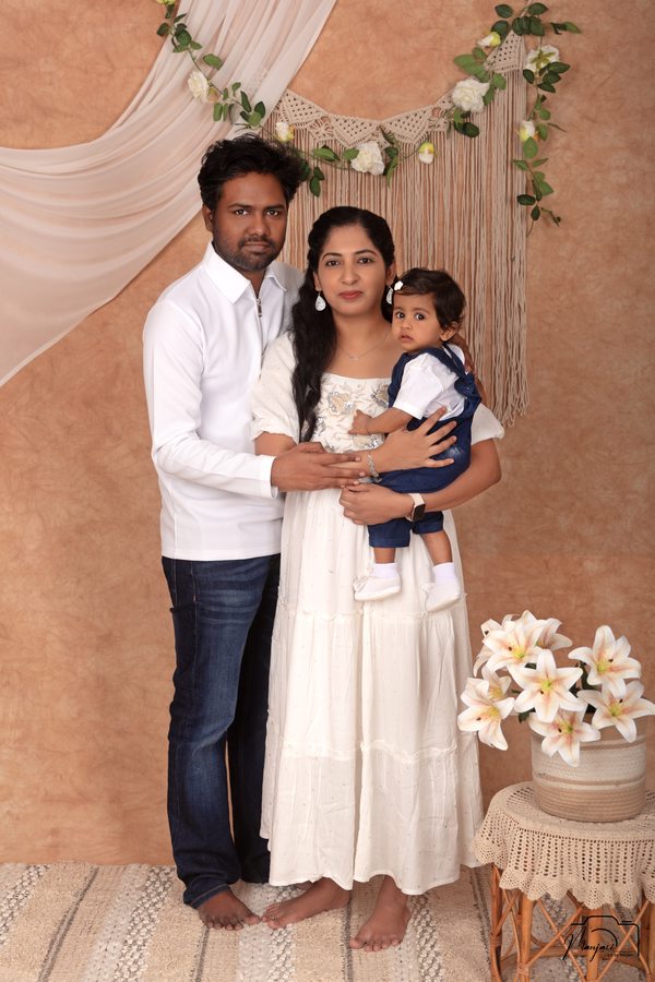 Family together at a warm neutral floral studio set