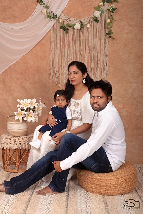 Family seated together in a warm neutral studio