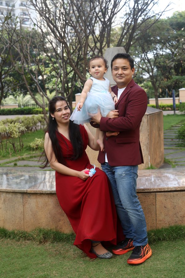 Family standing together in a green garden