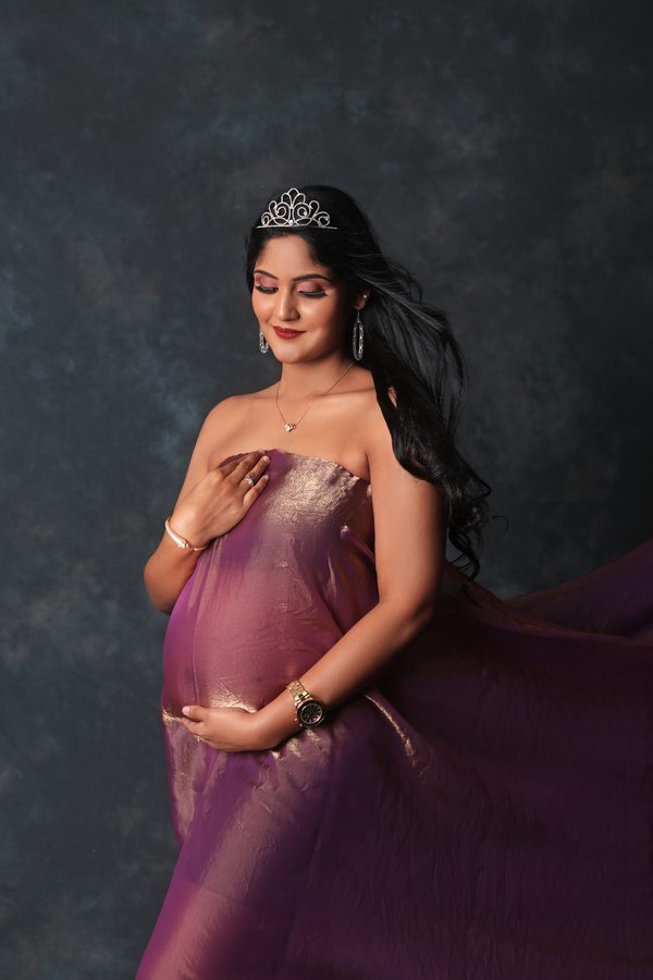 Fine-art maternity portrait in a lilac gown and tiara