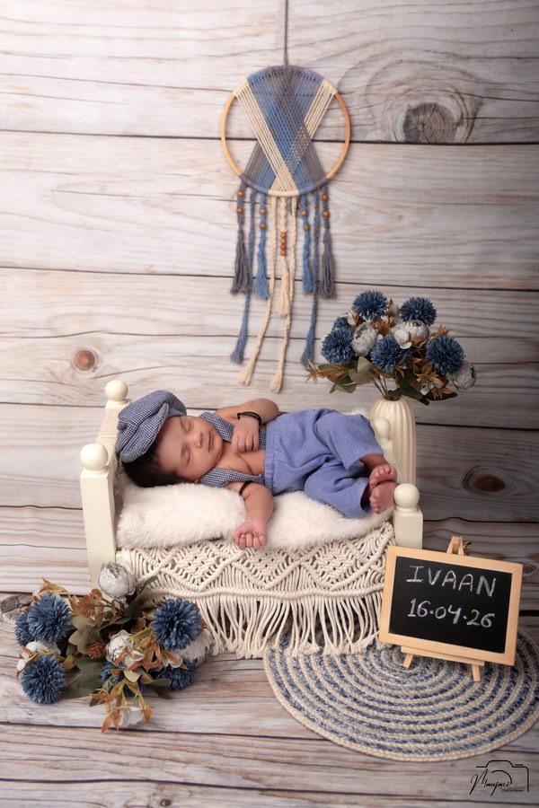 Newborn sleeping in blue with dreamcatcher details